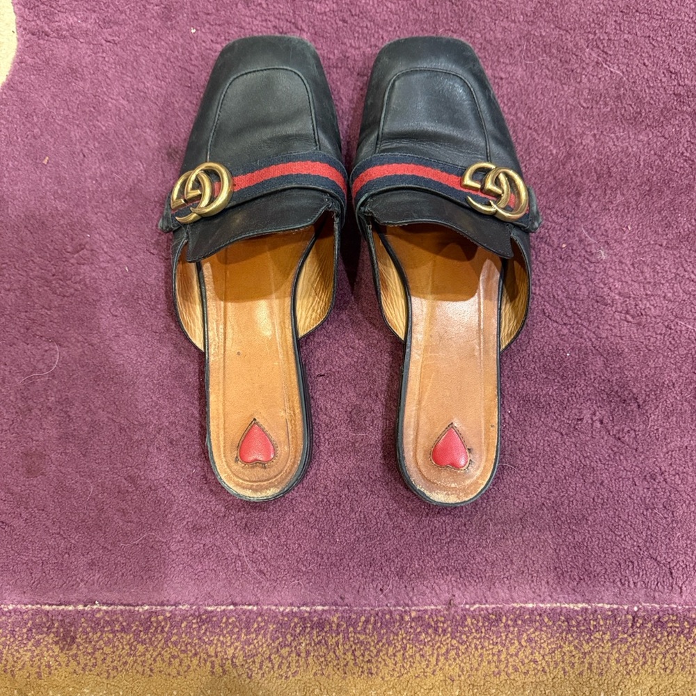 Gucci Black Flats with Gold Emblem and Red Stripe